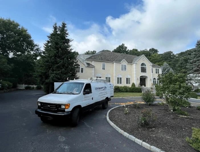 Strongsville Power Washing technician performing thorough gutter cleaning service in Strongsville